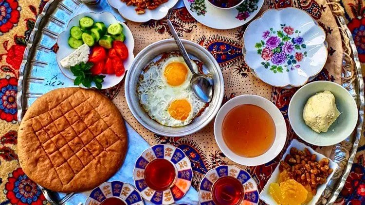 Selection of foods and drinks from across the Muslim World on a patterned table cloth.