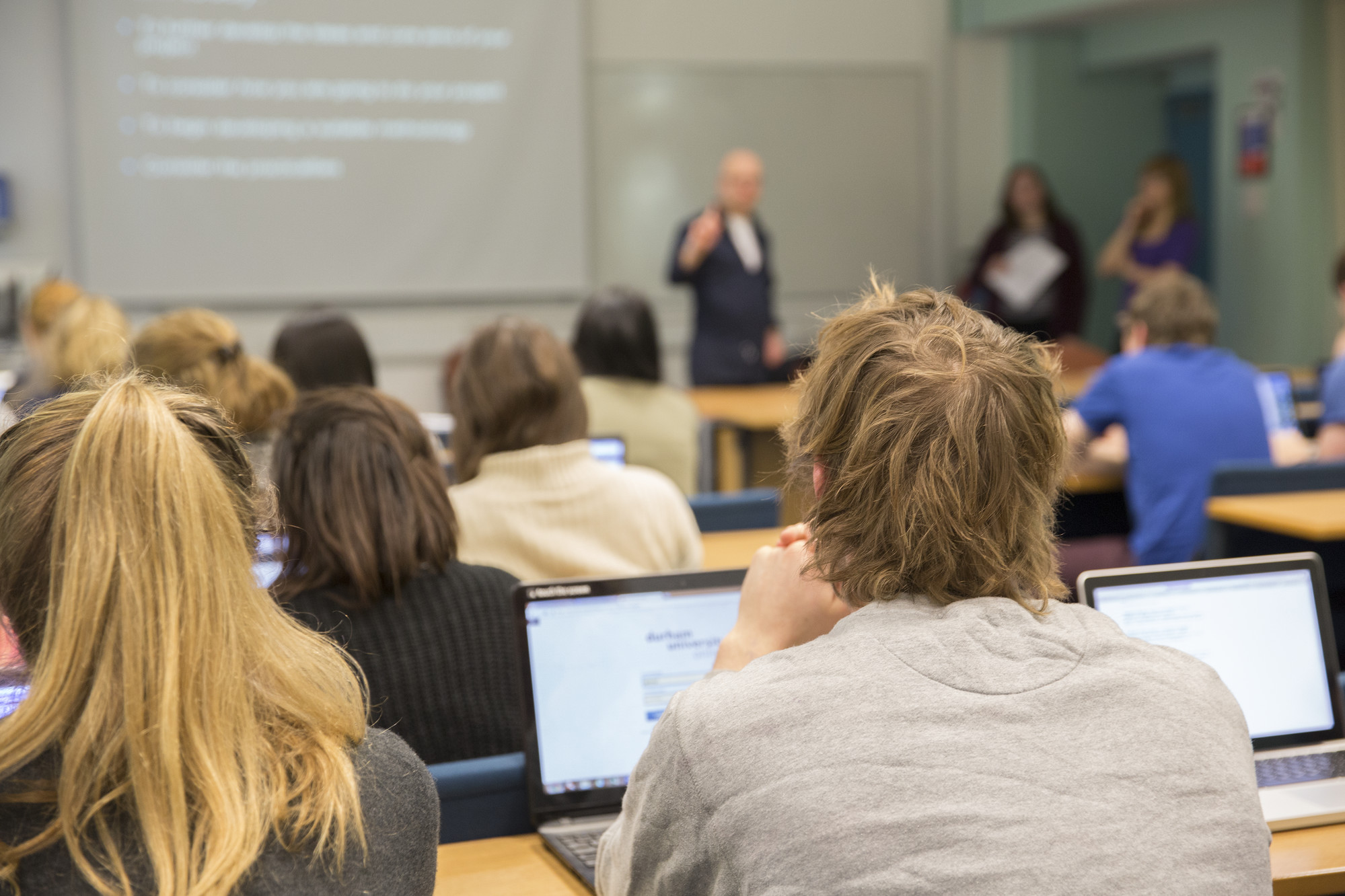 Students in seminar workshop with lecturer presenting