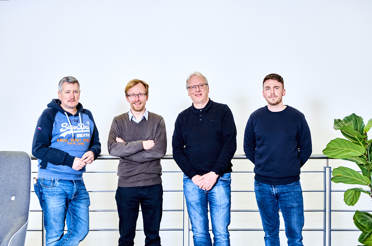 Photo of four members of the Precision Optics team