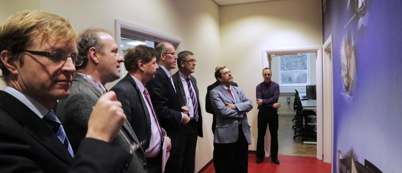 Alain Aspect admires the mural outside the Physics dept labs as other academics look on