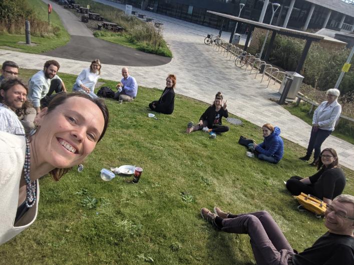 Psychology staff meeting for lunch, sitting on the grass