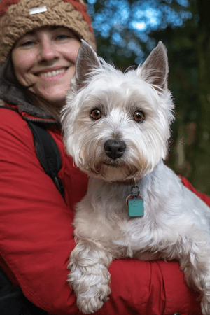 An academic holding her dog