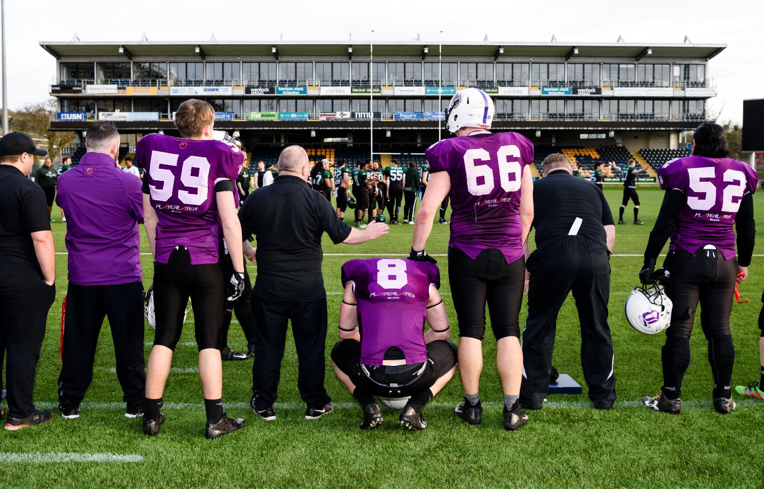 An American football team with their backs to camera