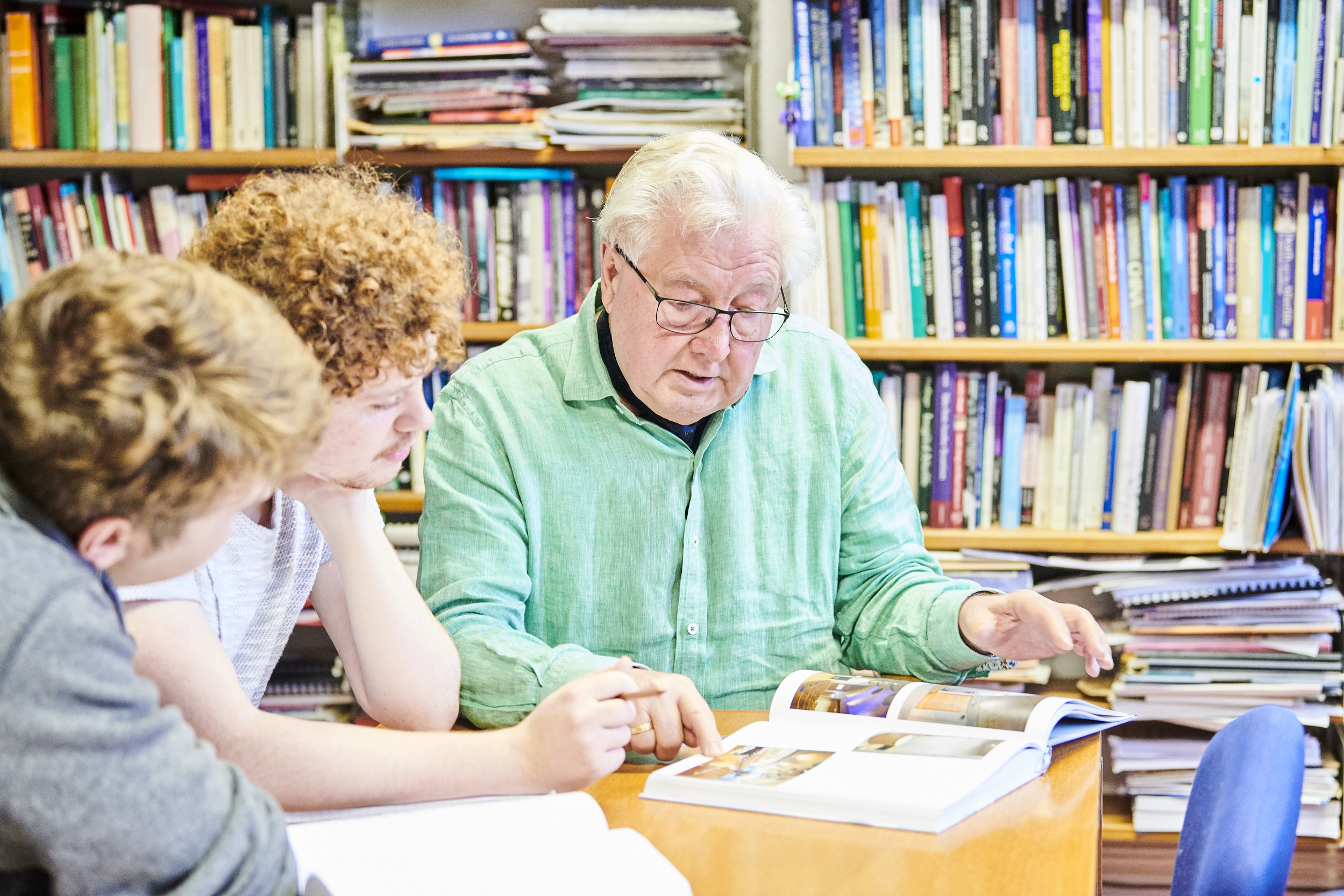Tutor reading through book with students