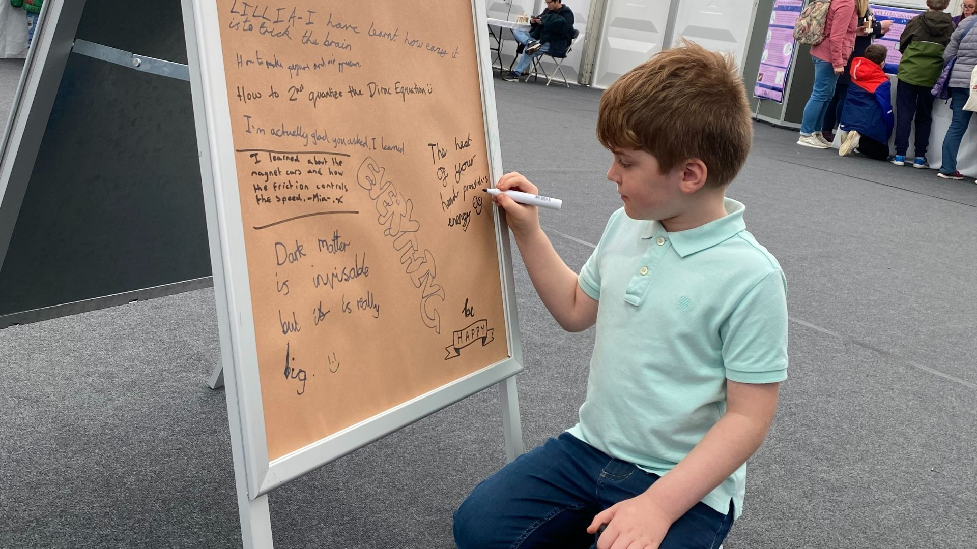 A child writing on a board