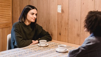 Students sitting at a desk chatting