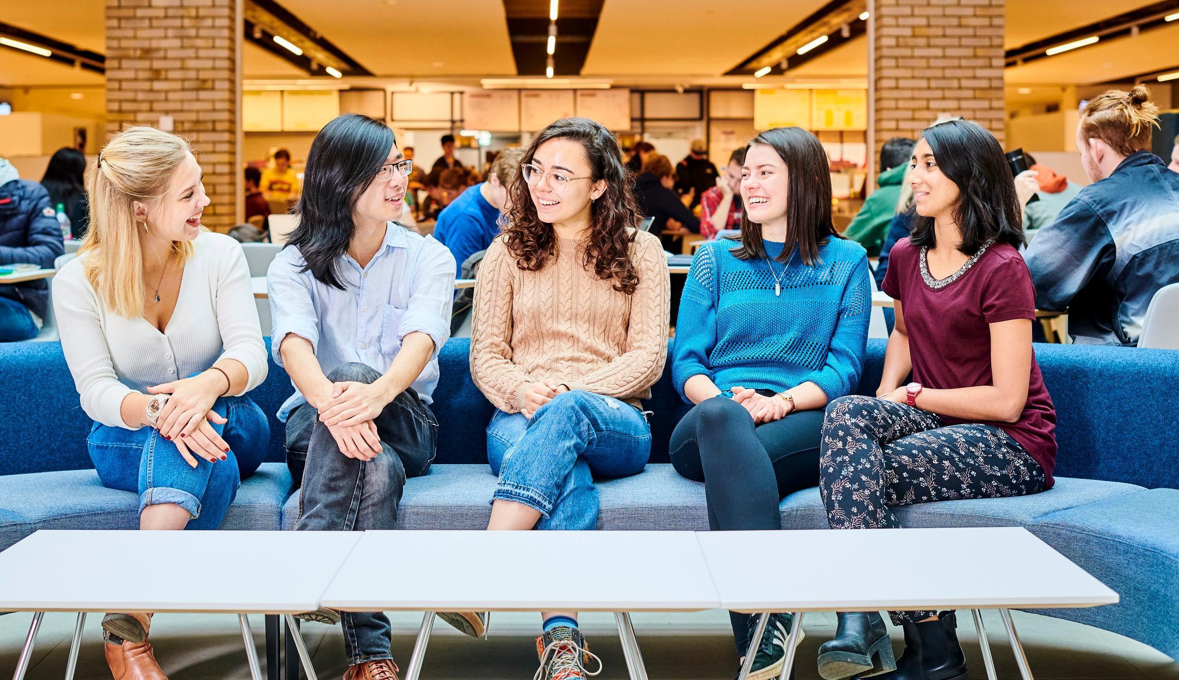 Group of students talking inside Teaching and Learning Centre