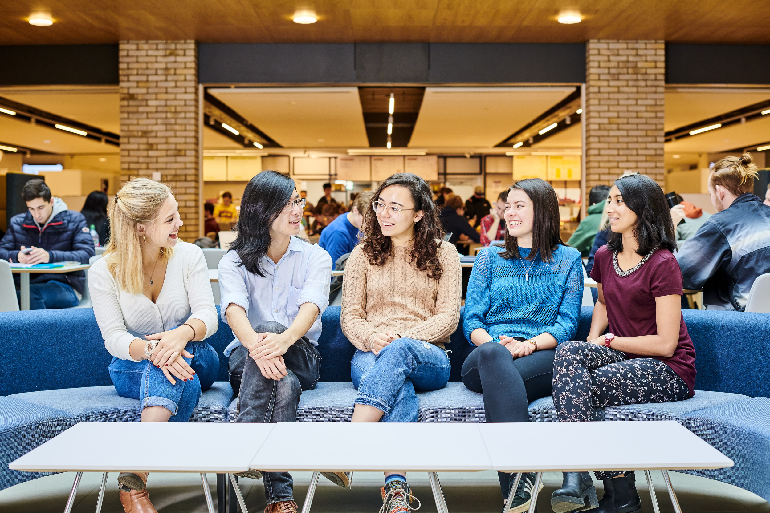 Group of students talking inside Teaching and Learning Centre