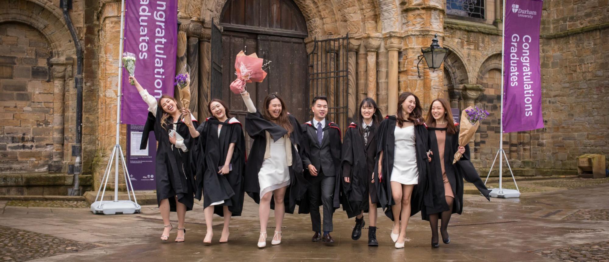 Graduates celebrating outside Durham Cathedral
