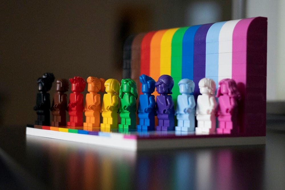 Lego pieces standing in a rainbow