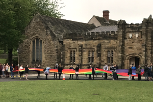 Large group of people celebrating LGBTQ History Month