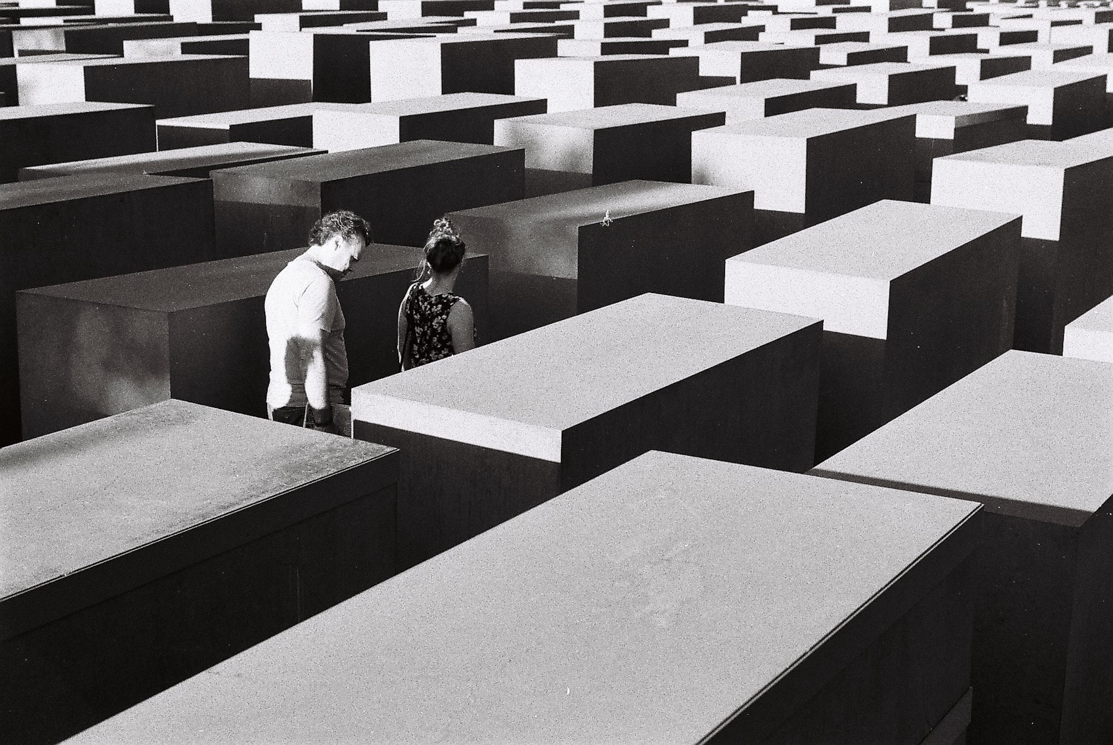 Two people in Holocaust memorial - black and white