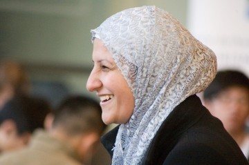 A woman in a headscarf smiling