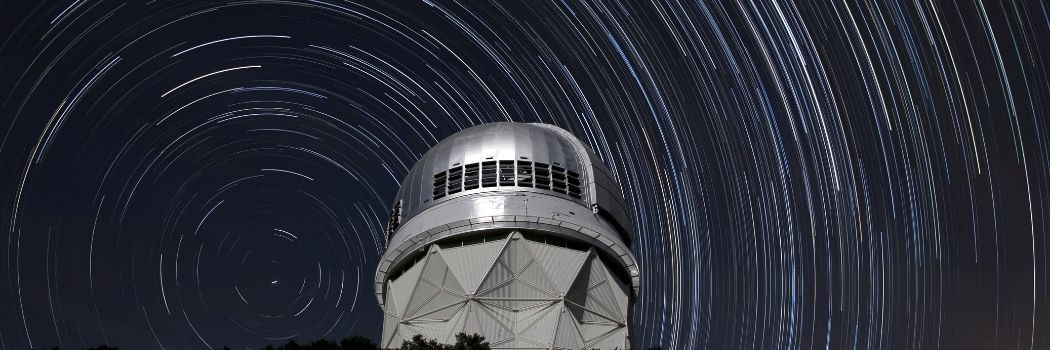 Star trails over a telescope