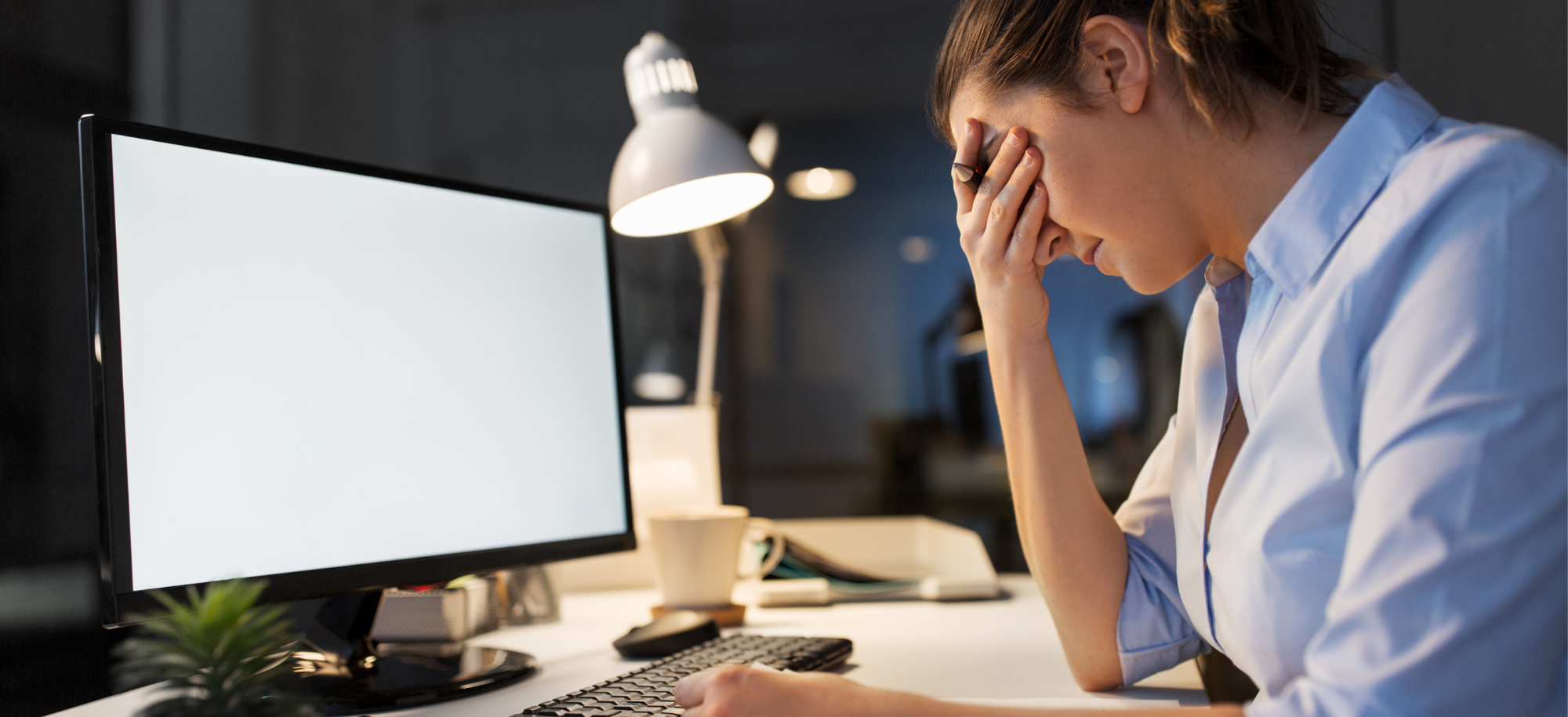 A woman struggling with long COVID at the computer.