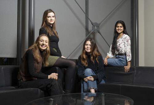 A group of four interns sitting on a sofa