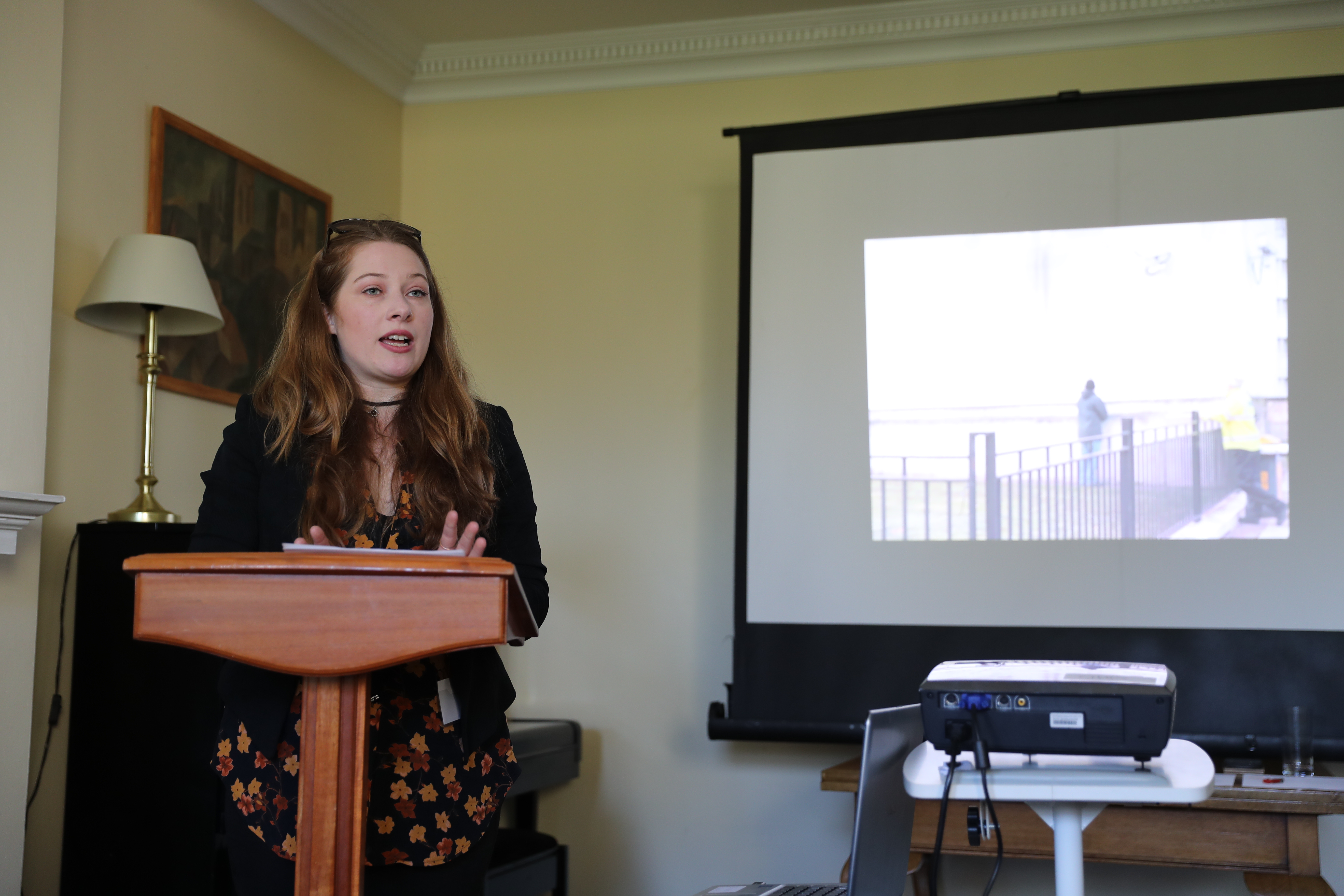 A woman giving a lecture to students