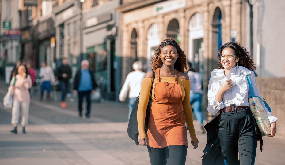 People crossing Elvet Bridge on a warm, sunny day