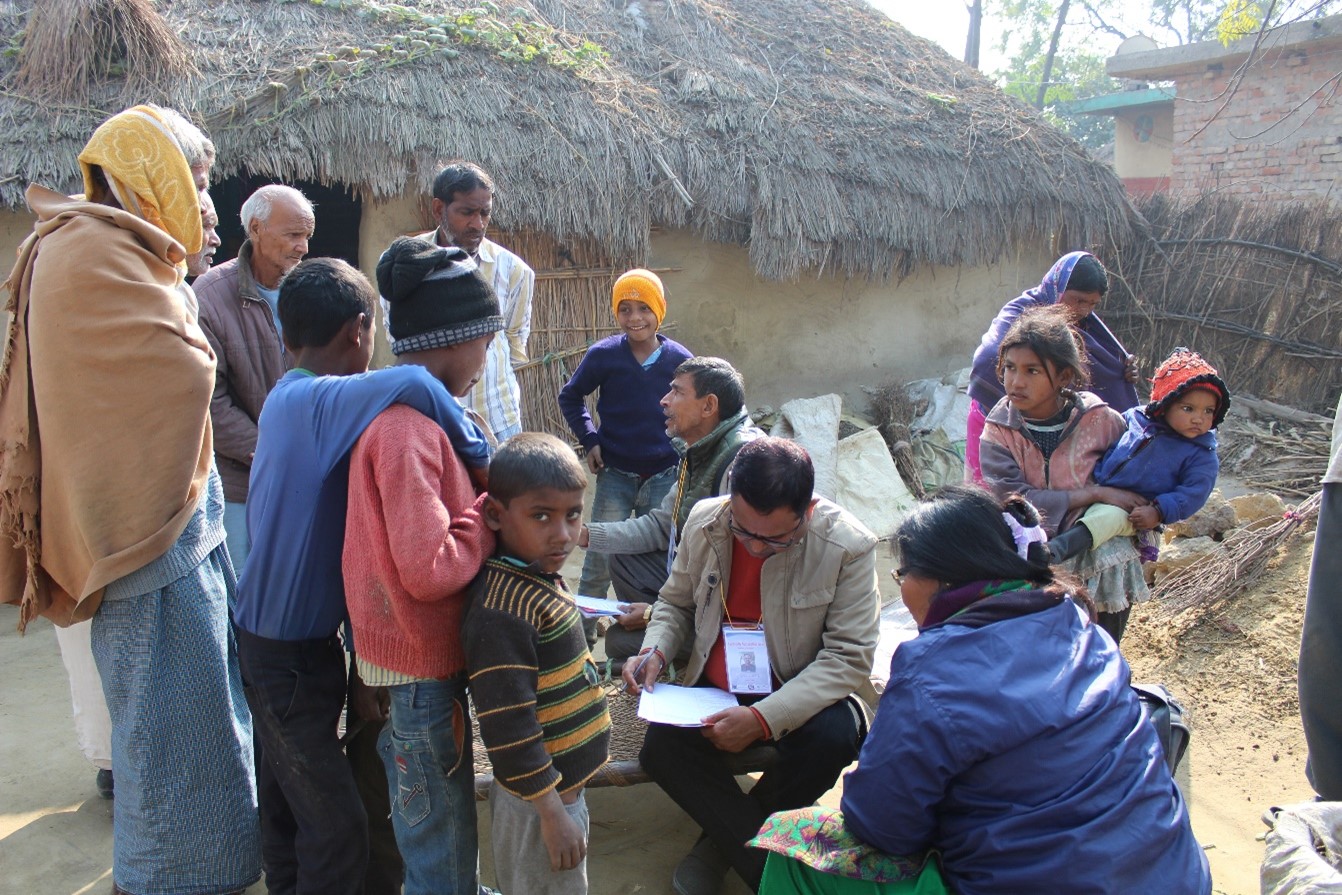 A team member interviews villagers in Dohani Nepal