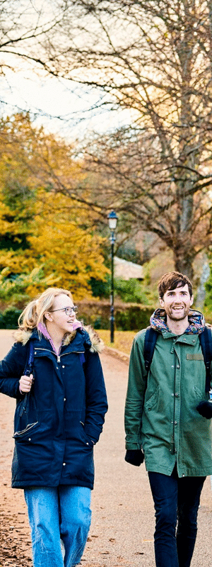 Two students walking in the park.
