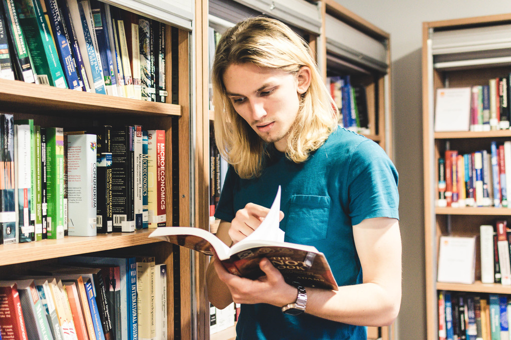 TStudent in library looking at book