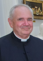 A smiling man wearing a clerical collar