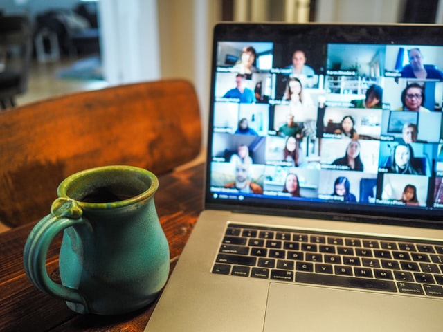 Picture of mug with a laptop screen showing a Zoom call