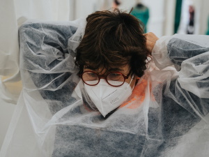 A woman putting on PPE