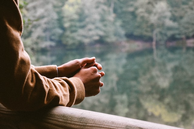 Clasped hands of a person in contemplation