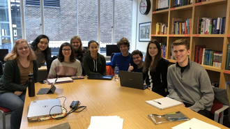 Class of 2019 smiling around a table