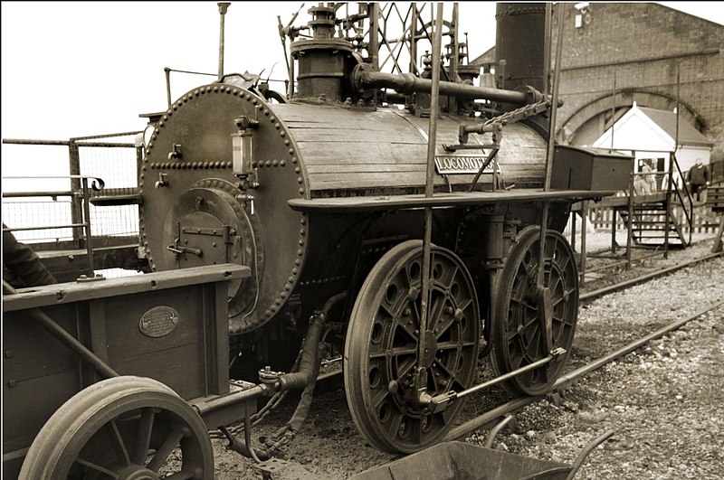 An old black and white photograph showing George Steventon's 'Locomotion 1' steam engine in a railway siding