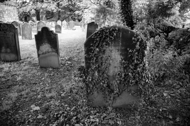 An old black and white image of a gravestone