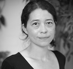 A smiling Japanese woman with her hair pulled back