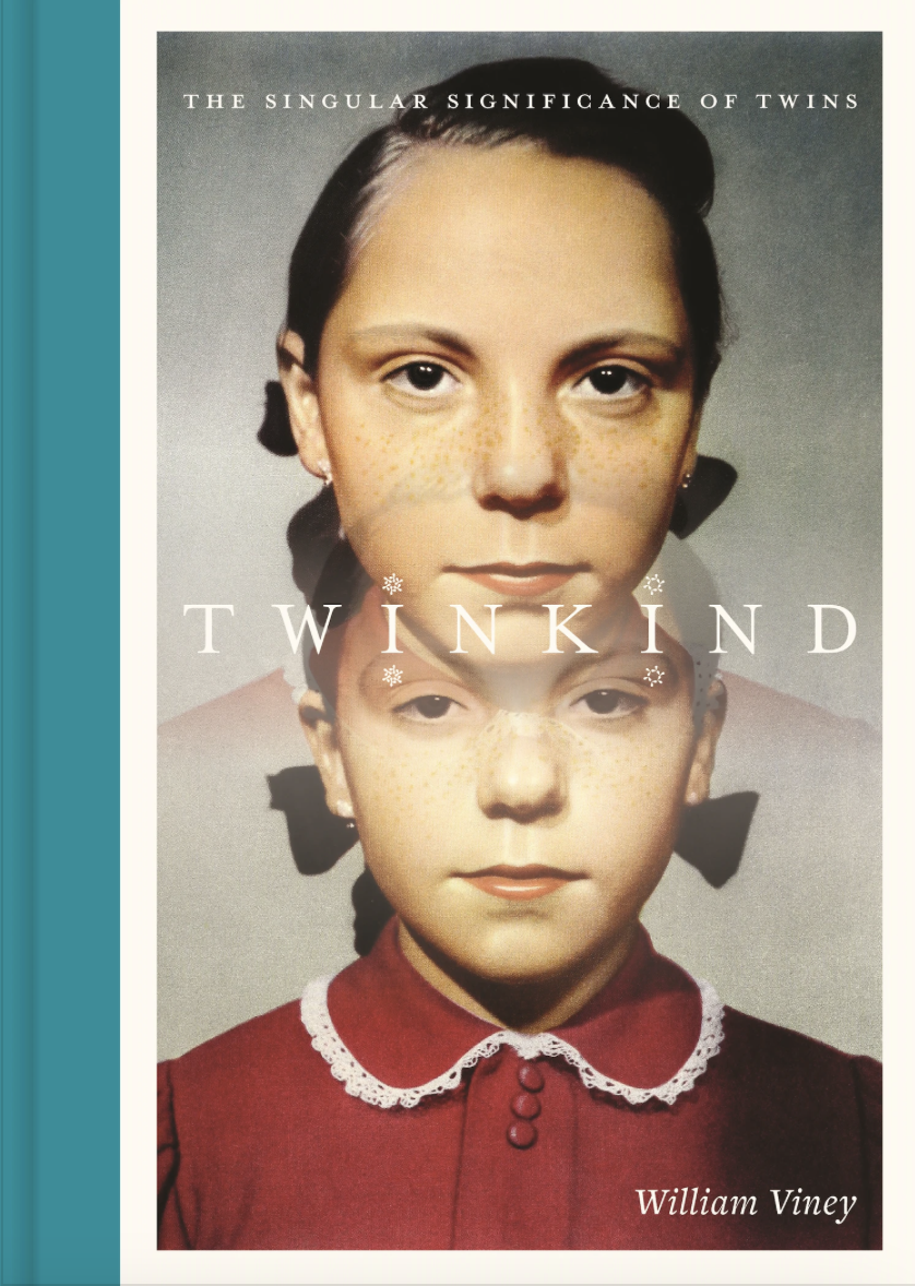 The cover of a book called Twinkind showing the faces of two identical young girls in a red dress