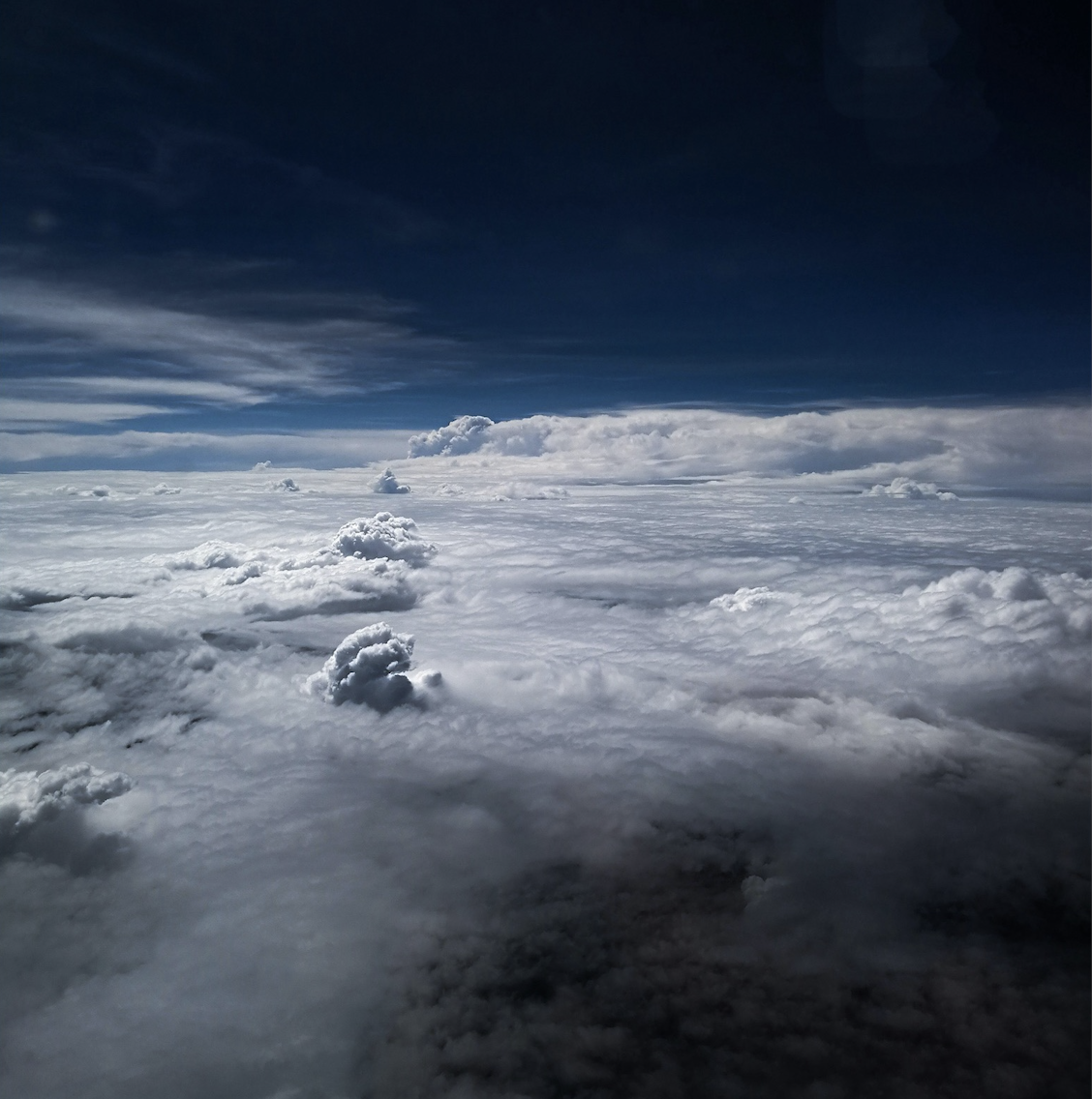 Clouds viewed from above against a dark sky