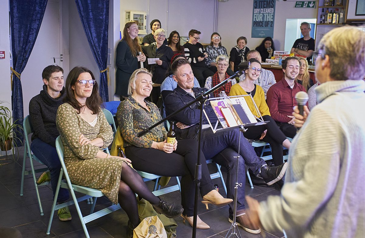 Audience laughing at stand-up by researcher.