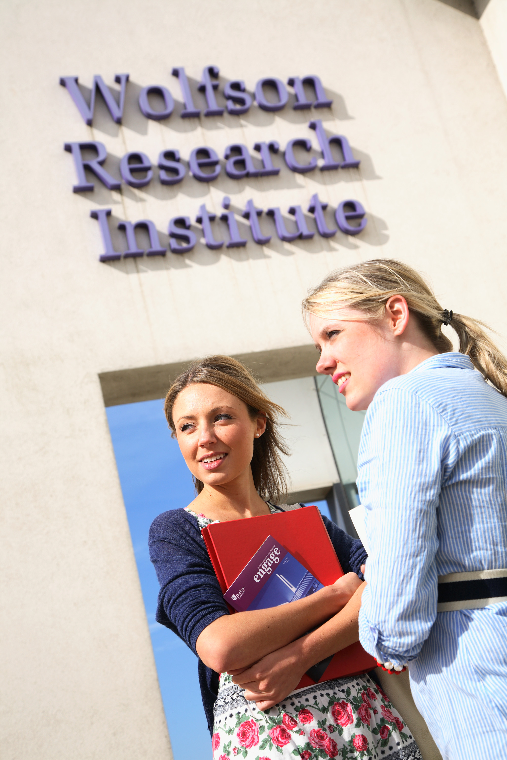 Two people stood outside the Wolfson Research Institute