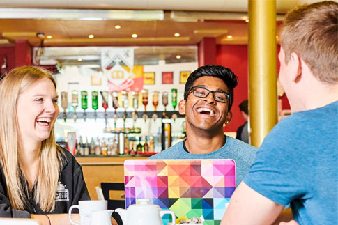 Students sitting around a table in a cafe