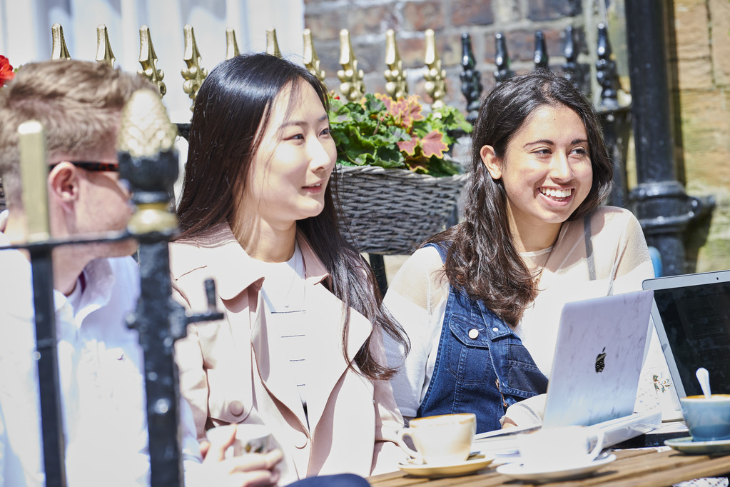 Students chatting at a cafe.