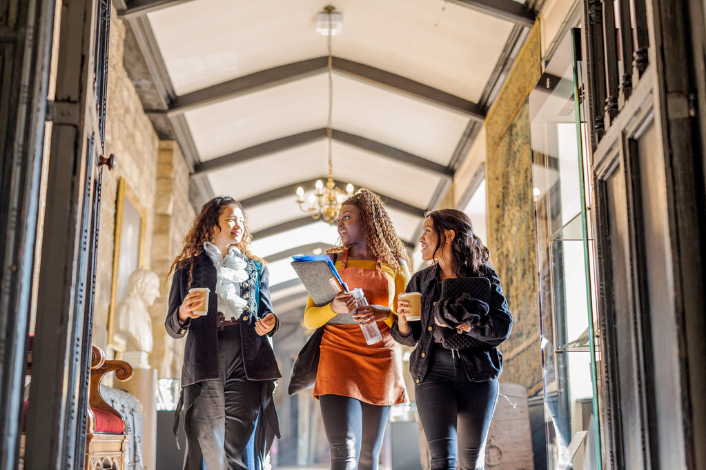 Three International Students walking through a building