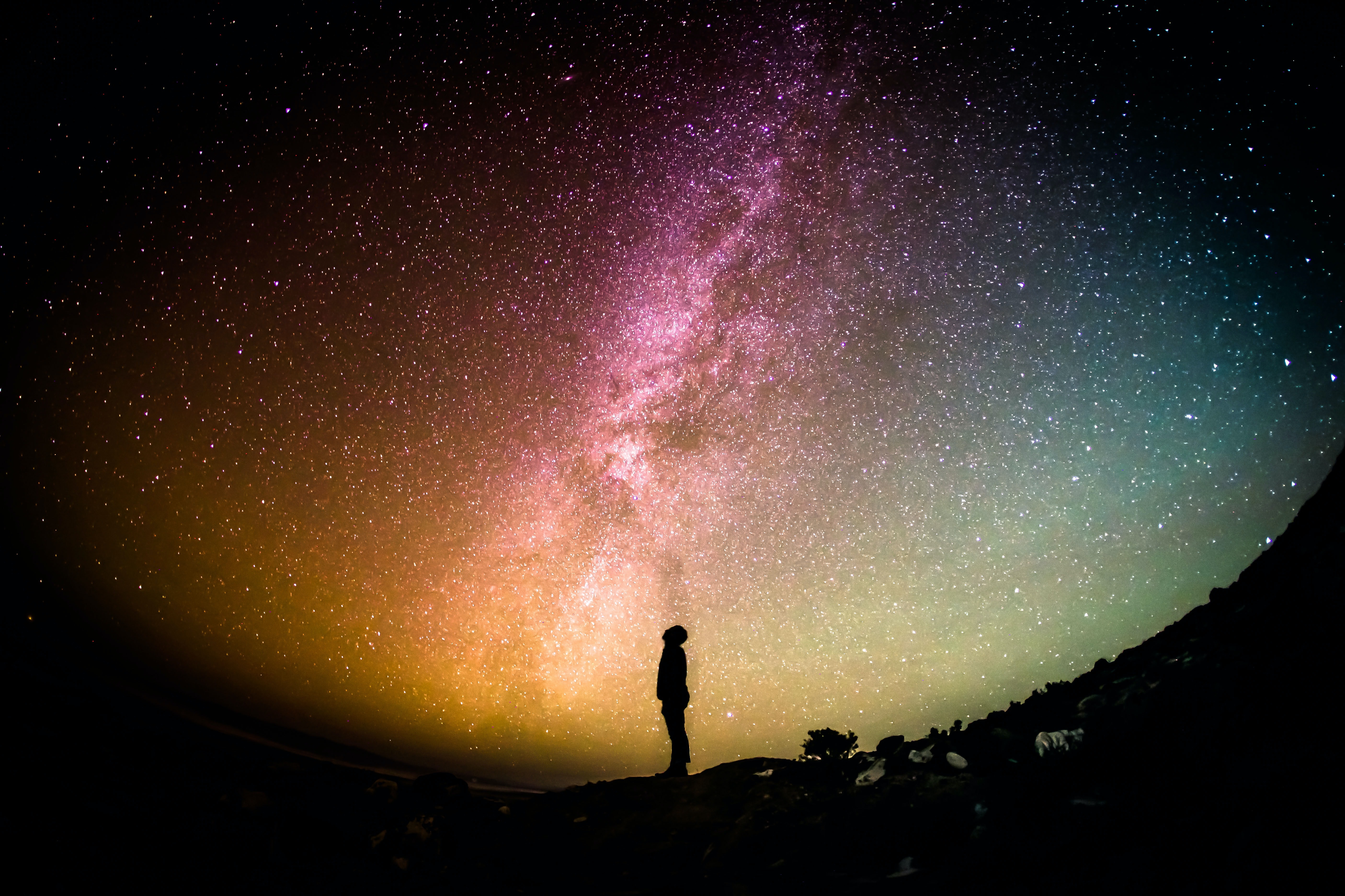Silhouette of a person under the milky way