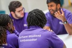 Four Durham Student Ambassadors chatting around a table