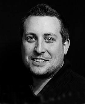 Black and white profile photo of James Fox-Robinson
