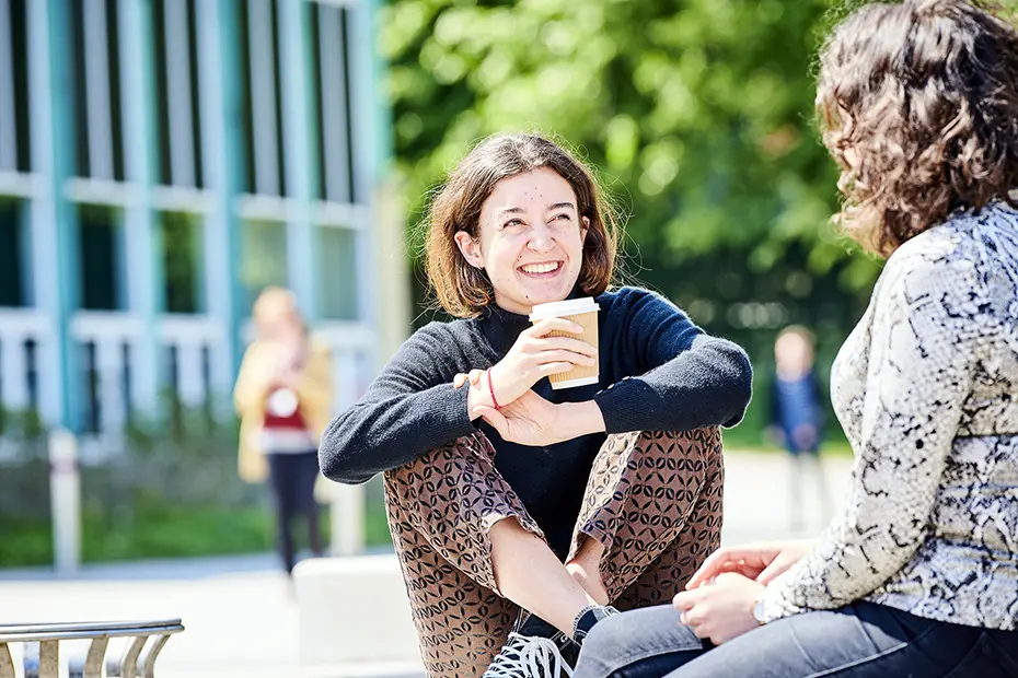 Two students talking on campus