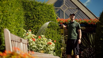 Botanic Garden gardener watering flowers