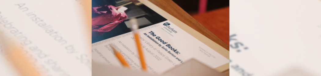 Close-up detail of the opening invitation for ‘The Good Books’ art installation, a pot with pencils is in the foreground, out of focus.