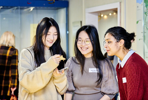 Three student volunteers smiling
