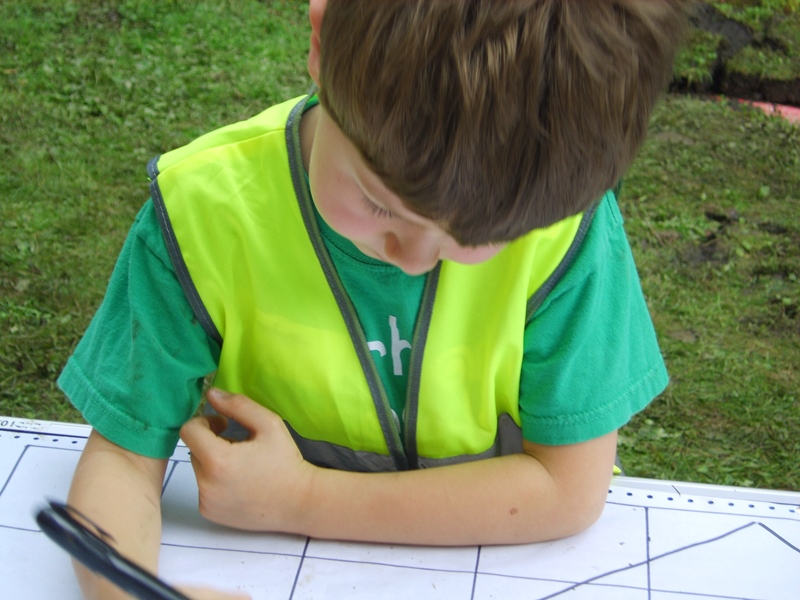 Child in high-vis jacket taking part in Durham Archaeology Explorers