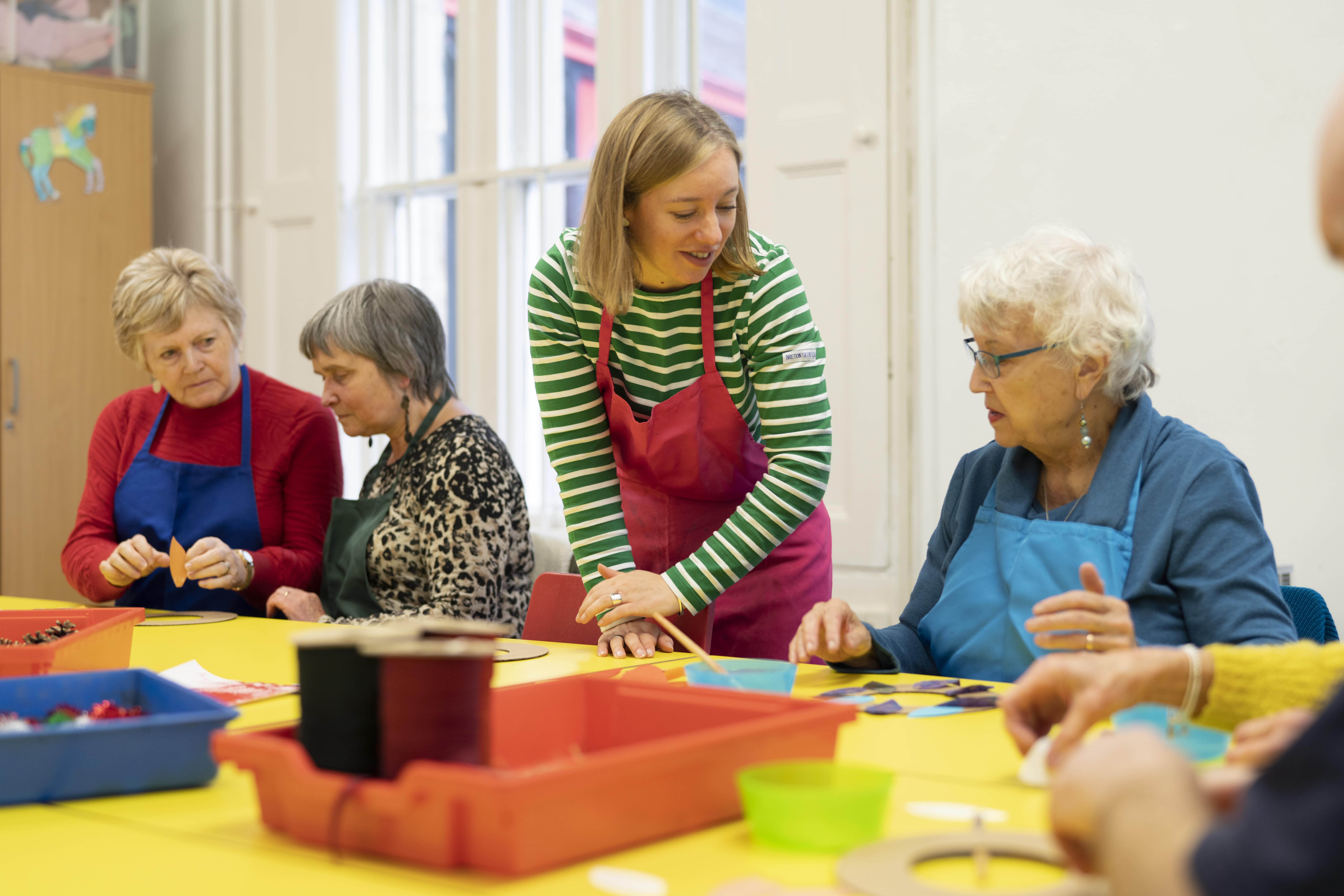 A group taking part in a craft activity at Creative Age