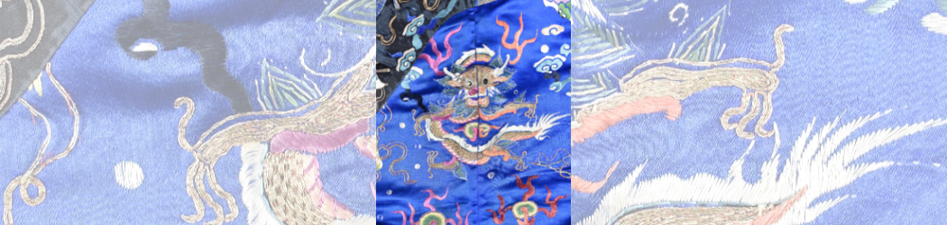 Zoomed in view of a detail on an imperial Chinese robe showing a Chinese dragon on a blue background surrounded by various symbols.